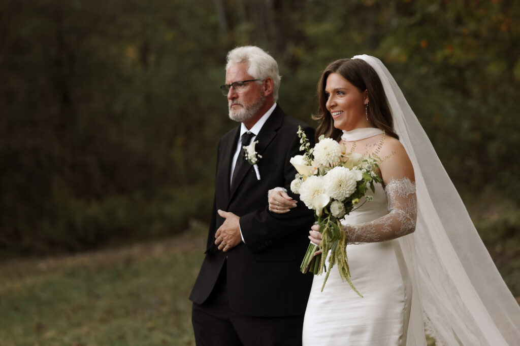 Emma walking down the aisle on her dad’s arm