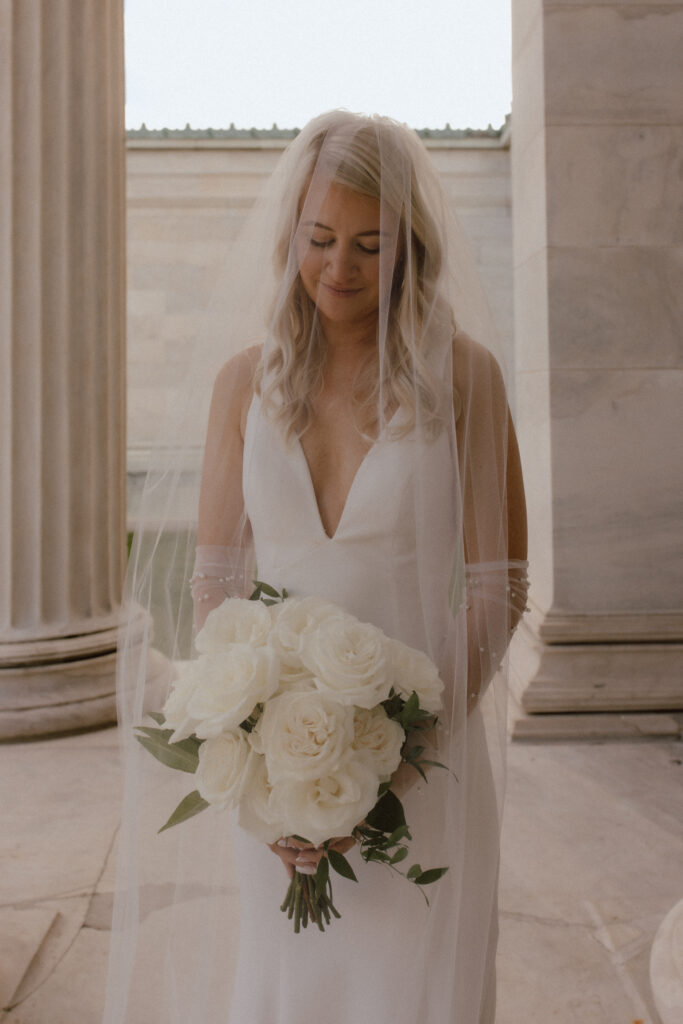 A close photo of a bride holding Catherine Rose florals