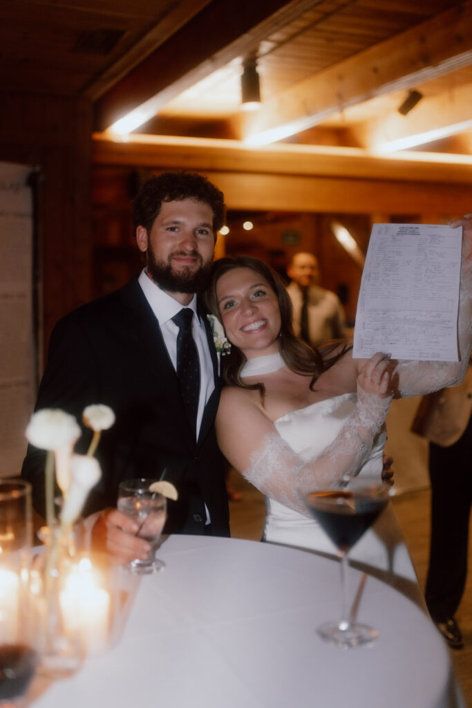 Emma and Ryan signing their wedding documents at HoliMont Ski Resort during their Great Valley, NY wedding.