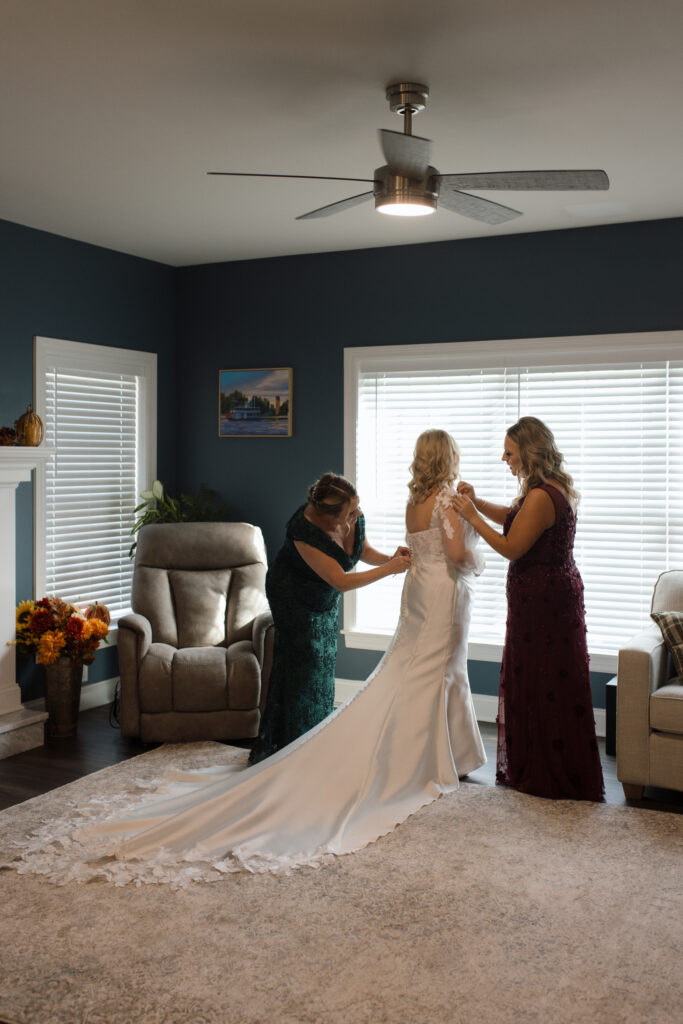 Bridal getting ready – Megan sharing a candid moment with her family while preparing for her wedding at Wurlitzer Events.